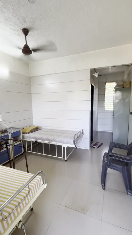 A bright, clean room at the home with a bed, a ceiling fan and a window