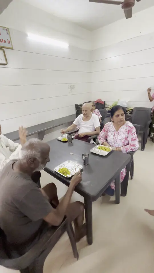 Residents seated together at the dining table, sharing a meal